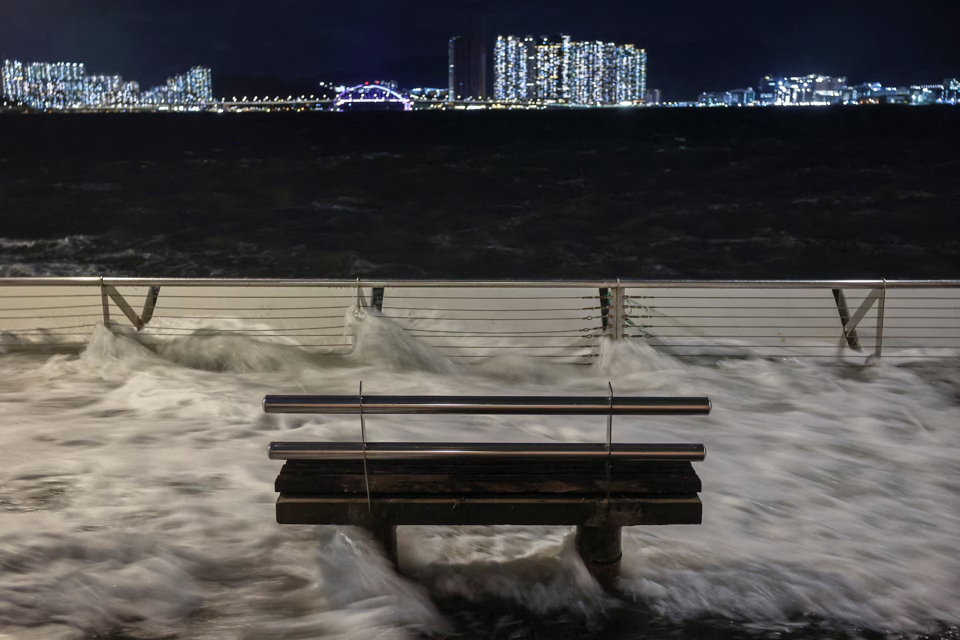Waves from Super Typhoon Ragasa crash onto chair by the shore in Hong Kong.jpg