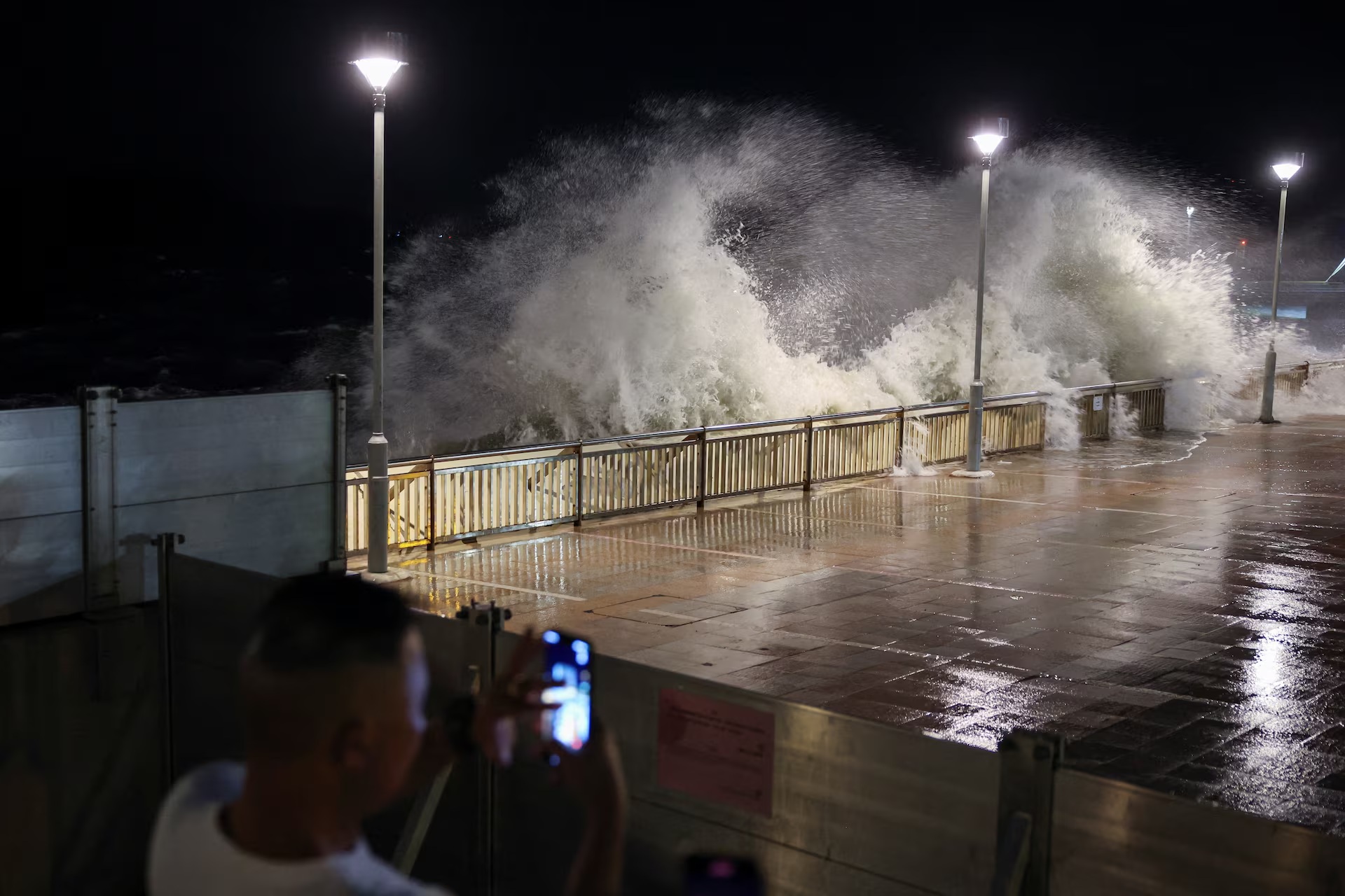 A resident takes photos of rough waves from the shore before Super Typhoon Ragas.jpg